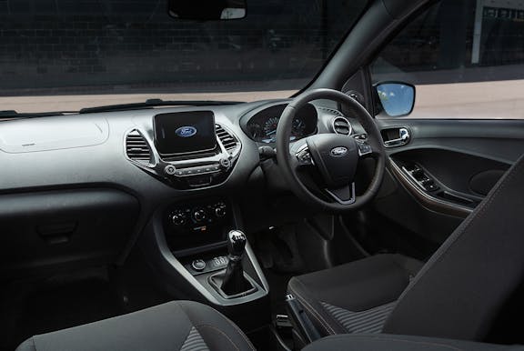 The interior of a Ford Ka with steering wheel and dashboard in shot