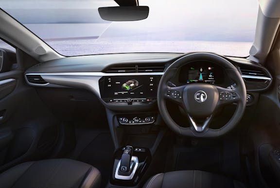The interior of a Vauxhall Corsa with steering wheel and dashboard in shot