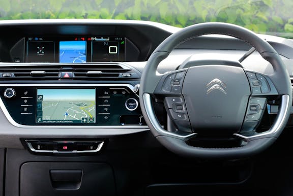 The interior of a Citroen Grand C4 Picasso with steering wheel and dashboard in shot