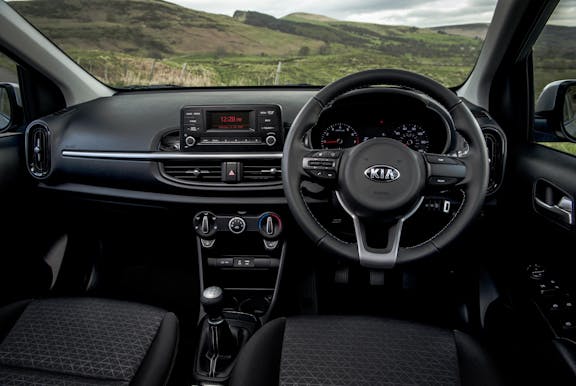 The interior of a Kia Picanto with steering wheel and dashboard in shot
