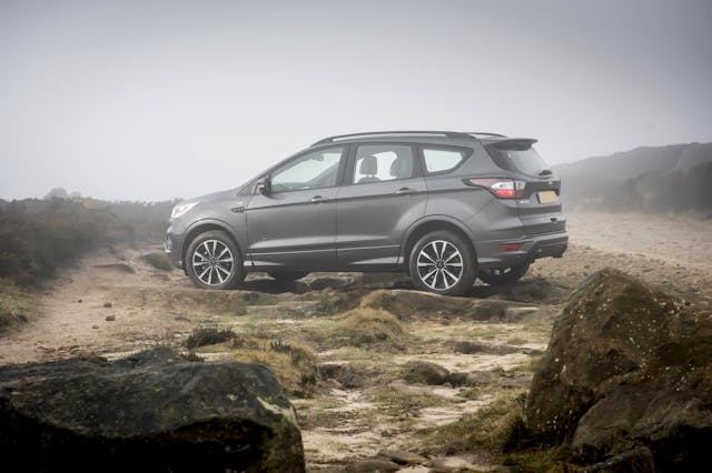 The side exterior of a black Ford Kuga