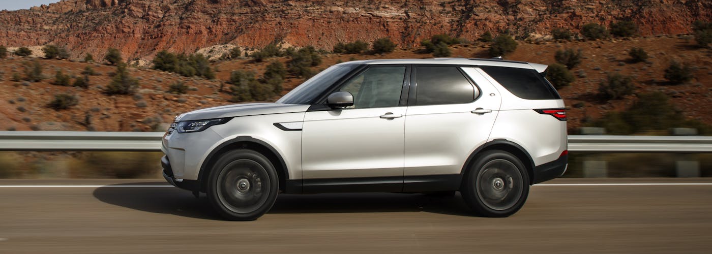 The side exterior of a silver Land Rover Discovery