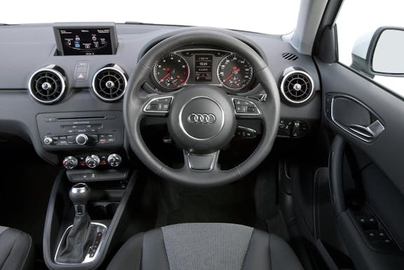 The interior of an Audi A1 with steering wheel and dashboard in shot