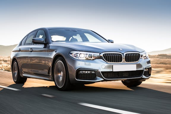 The front exterior of a silver BMW 5 Series
