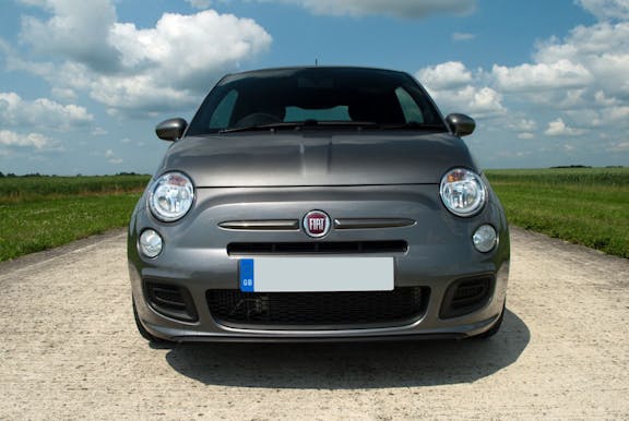 The front exterior of a silver Fiat 500