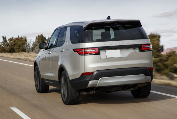 The rear exterior of a silver Land Rover Discovery