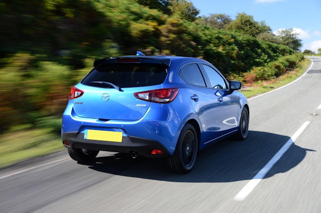 The rear exterior of a blue Mazda 2