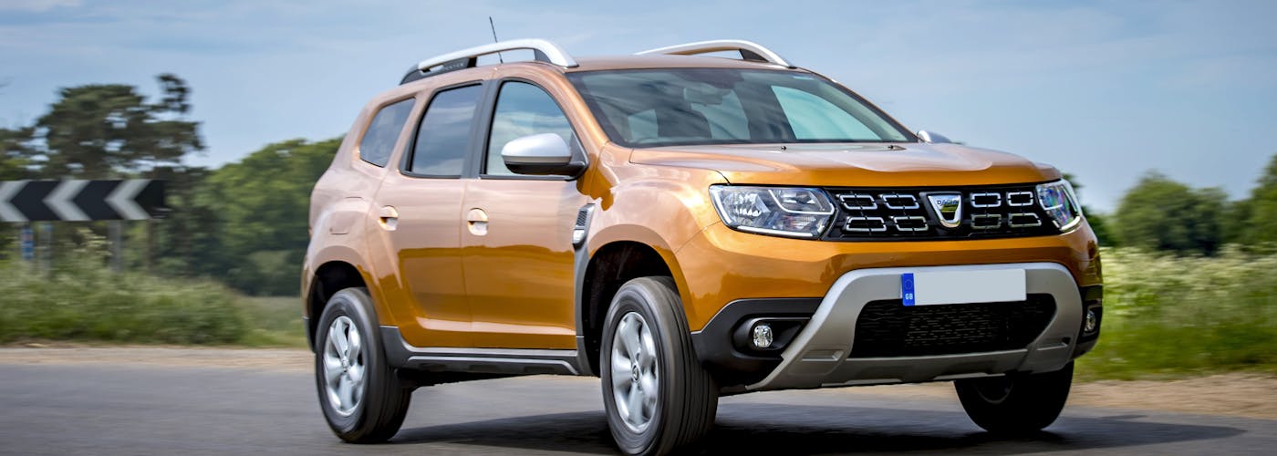 The exterior of a yellow Dacia Duster