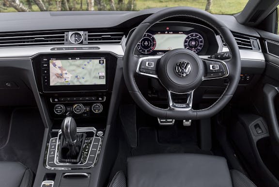 The interior of a Volkswagen Arteon with steering wheel and dashboard in shot