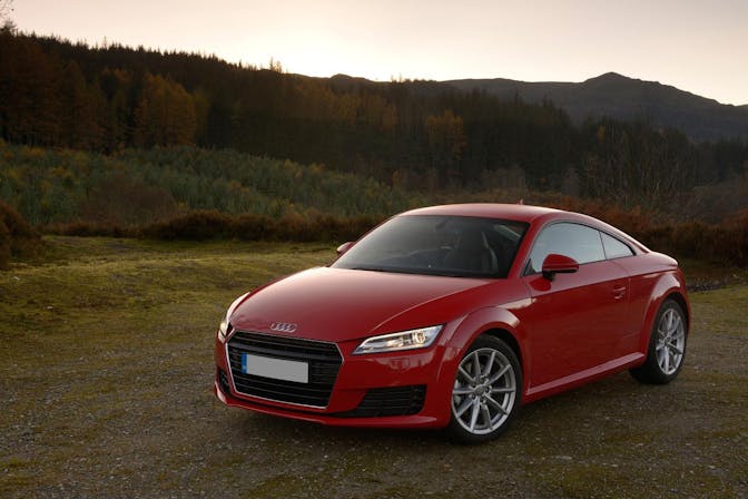 The front exterior of a red Audi TT