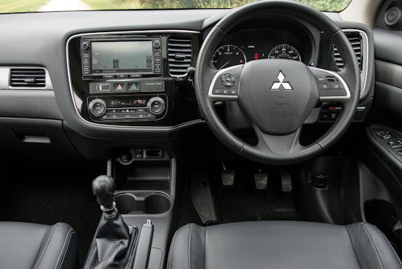 The interior of a Mitsubishi Outlander with steering wheel and dashboard in shot