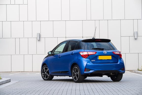 The rear exterior of a blue Toyota Yaris