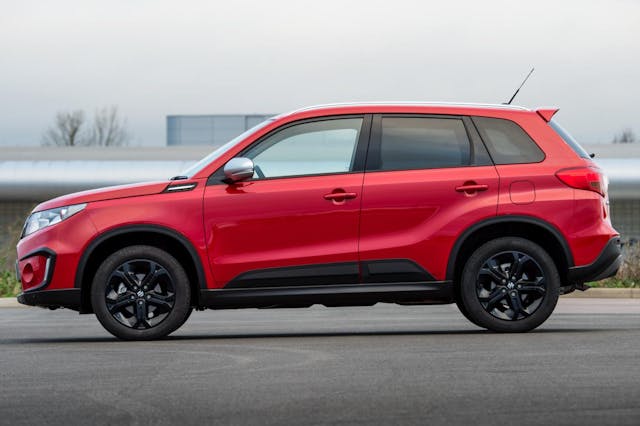The side exterior of a red Suzuki Vitara