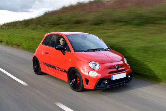 The front exterior of a red Abarth 595