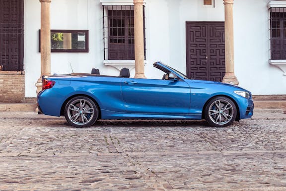 The exterior of a BMW 2-Series with roof down