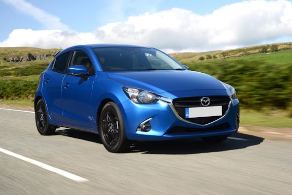 The front exterior of a blue Mazda 2