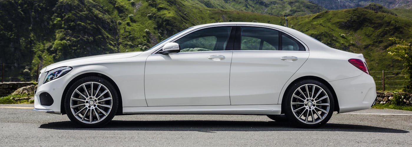 The side exterior of a white Mercedes-Benz C-Class