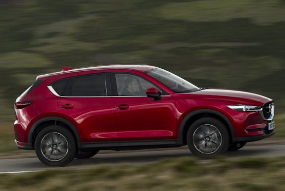 The side exterior of a red Mazda CX-5