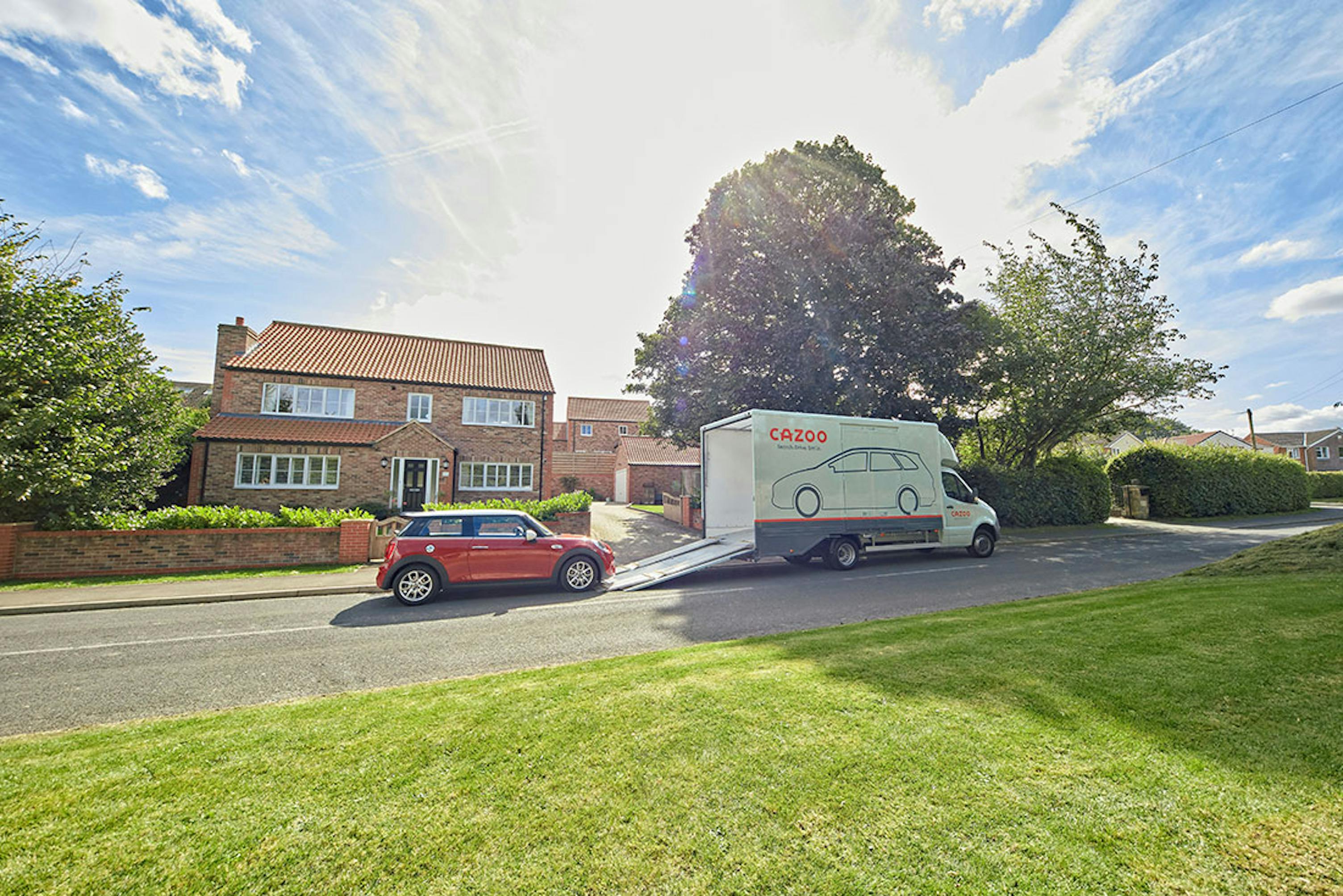 Cazoo car transporter outside house