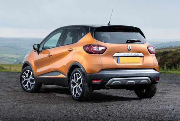 The rear exterior of a yellow Renault Captur