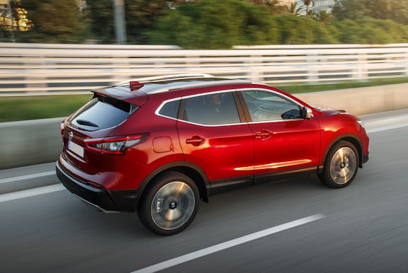 The rear exterior of a red Nissan Qashqai