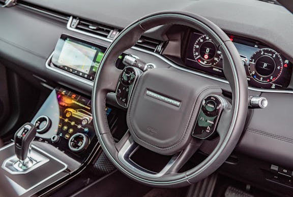 The interior of a Land Rover Range Rover Evoque with steering wheel and dashboard in shot