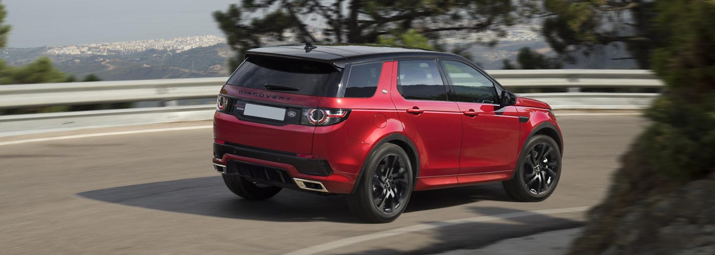 The rear exterior of a red Land Rover Discovery Sport