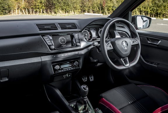 The interior of a Skoda Fabia with steering wheel and dashboard in shot