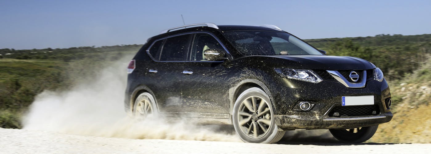 The front exterior of a black Nissan X-Trail