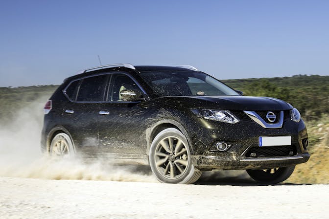 The front exterior of a black Nissan X-Trail