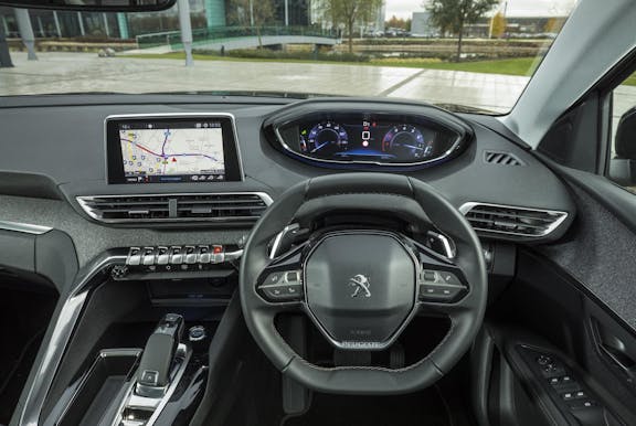 The interior of a Peugeot 3008 with steering wheel and dashboard in shot