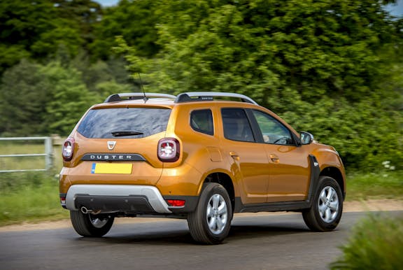 The rear exterior of a gold Dacia Duster
