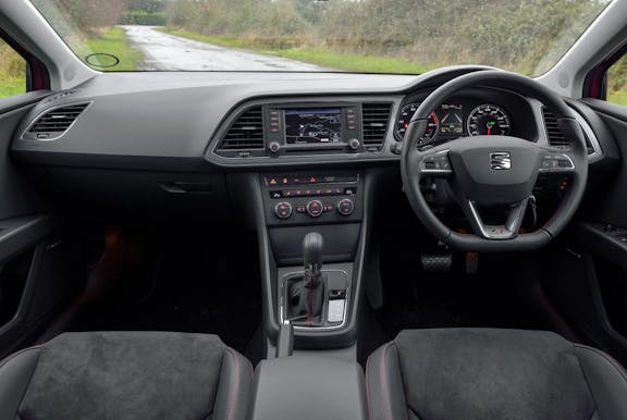 The interior of a Seat Leon with steering wheel and dashboard in shot