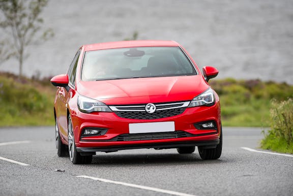 The front exterior of a red Vauxhall Astra