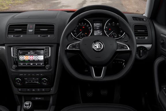 The interior of a Skoda Yeti with steering wheel and dashboard in shot