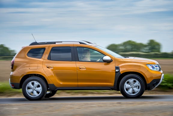 The side exterior of a gold Dacia Duster