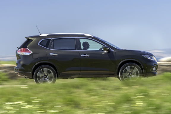 The side exterior of a black Nissan X-Trail