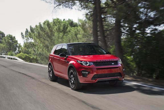 The front exterior of a red Land Rover Discovery Sport