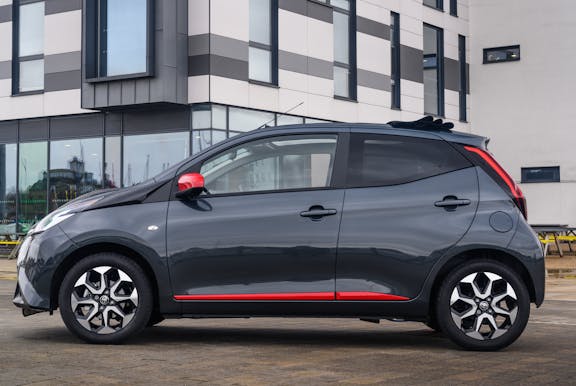 The side exterior of a grey Toyota Aygo