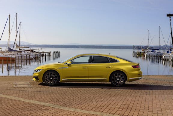 The side exterior of a yellow Volkswagen Arteon