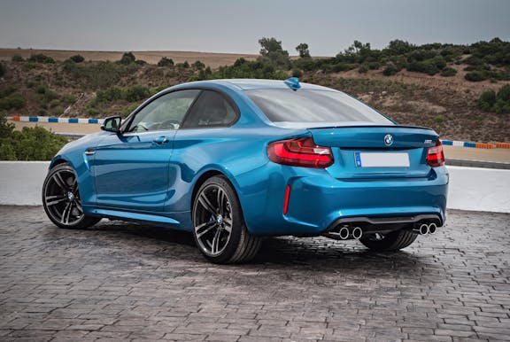 The rear exterior of a blue BMW M2