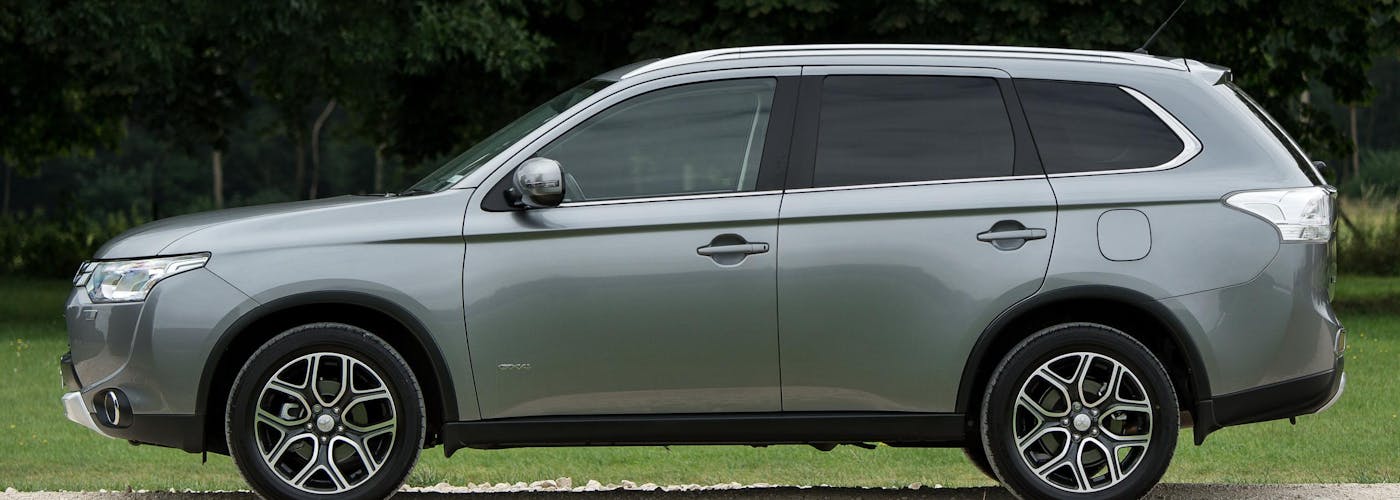 The side exterior of a silver Mitsubishi Outlander
