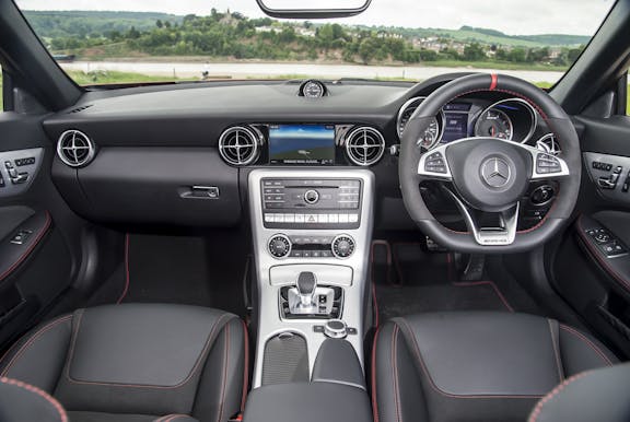 The interior of a Mercedes-Benz SLC with steering wheel and dashboard in shot
