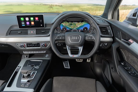 The interior of an Audi Q5 shot with dashboard and wheel