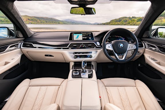 The interior of a BMW 7 Series with wheel and dashboard