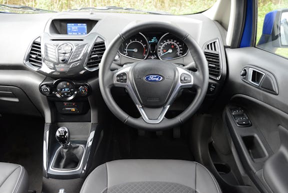 The interior of a Ford Ecosport with steering wheel and dashboard in shot