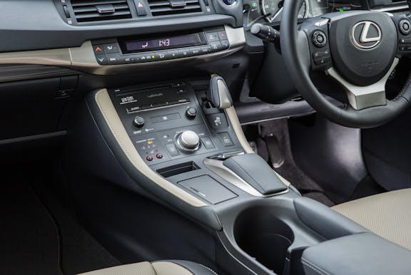 The interior of a Lexus CT with steering wheel and dashboard in shot