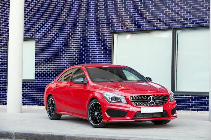 The front exterior of a red Mercedes-Benz CLA