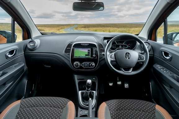 The interior of a Renault Captur with steering wheel and dashboard in shot