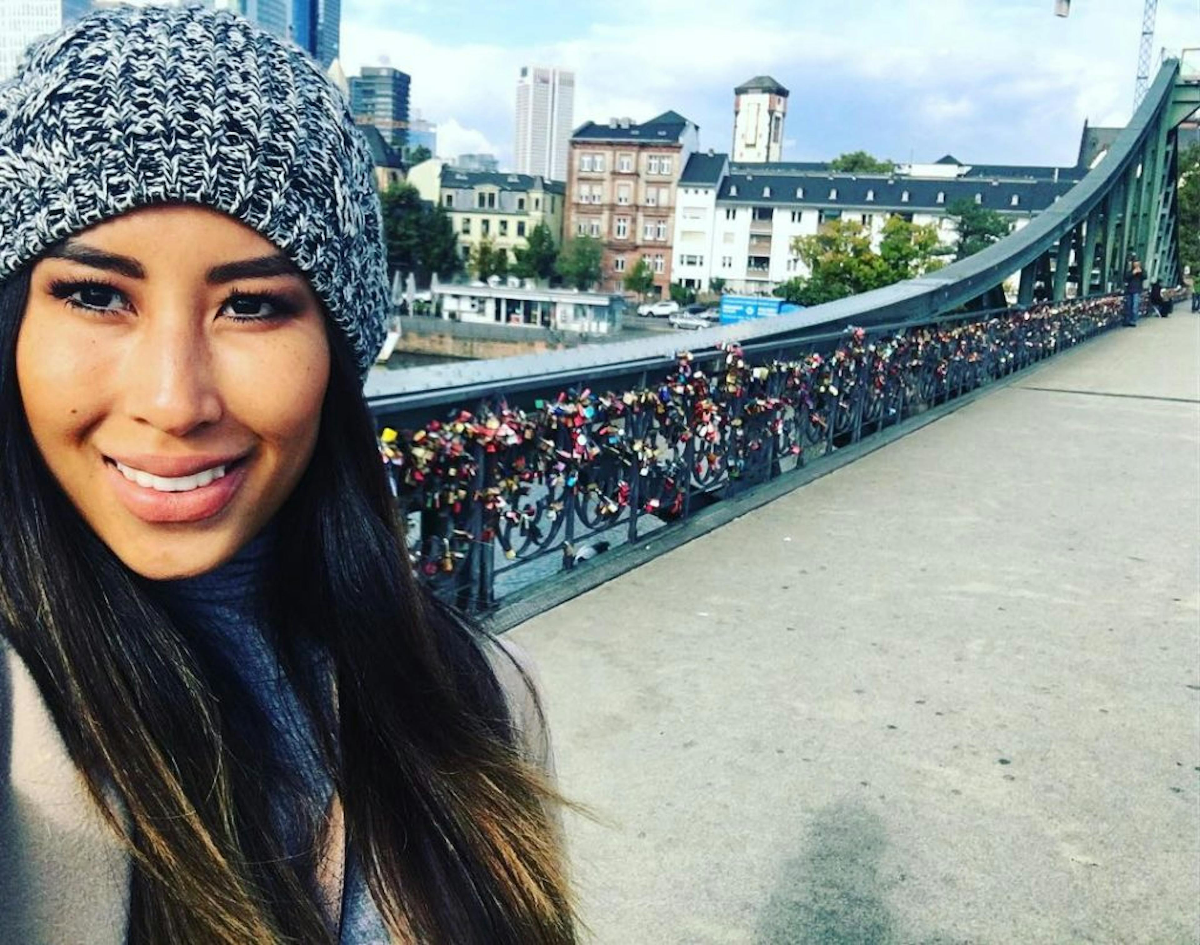 Intan Lay on love lock bridge half way through Invisalign.